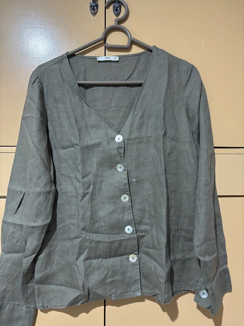 Mango Linen Button-Up Blouse (Category: Blouses) located in Davao. Submitted by teresa2002 (Listing ID 1413554740, Image 2). Description: With stain - Mango button-up blouse - V-neckline - Long sleeves with buttoned cuffs - Relaxed fit - Linen-like material - Button-down front - Muted green or grey color.