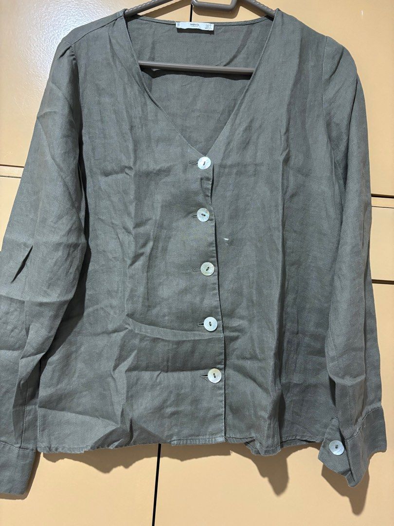 Mango Linen Button-Up Blouse (Category: Blouses) located in Davao. Submitted by teresa2002 (Listing ID 1413554740, Image 1). Description: With stain - Mango button-up blouse - V-neckline - Long sleeves with buttoned cuffs - Relaxed fit - Linen-like material - Button-down front - Muted green or grey color.