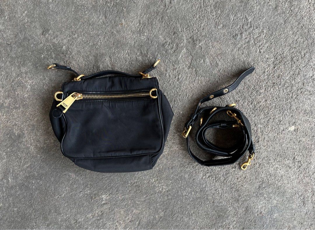 Moschino Black Nylon Shoulder Bag (Category: Luxury Bags & Wallets) located in General Santos City (Dadiangas). Submitted by thiftnibadi3 (Listing ID 1413492732, Image 2). Description: - Moschino black nylon shoulder bag - Gold-tone logo and hardware - Detachable shoulder strap - Interior pocket with Moschino Milano label - Zipper closure - Made of 100% nylon.