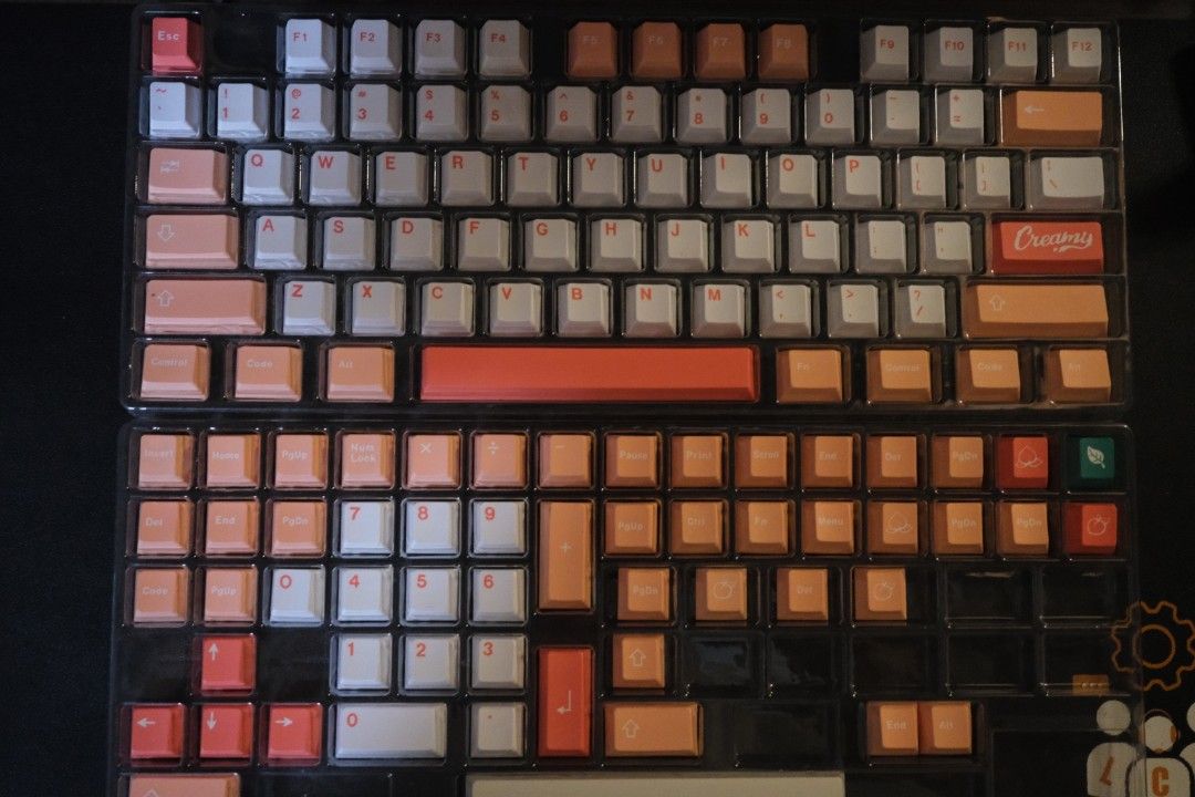 PBT Keycap 130 Key Cherry Profile Dye-Sub Peach Keycaps Set (Category: Computer Keyboard) located in Pasay City. Submitted by fruityorange (Listing ID 1413446832, Image 1). Description: Profile: Cherry Material: PBT Dye-Sub Keycap set that can fit most of keyboard profiles. Complete modifiers. Comes in clear tray with box. Keycap set featuring a mix of white, orange, and pink keycaps. The set includes keycaps for a full keyboard layout. The keyca