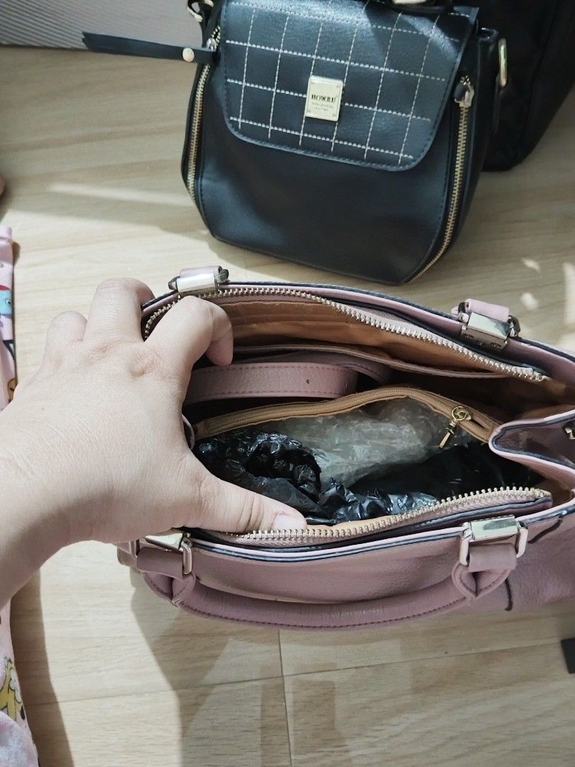 Pink Handbag with Top Handles (Category: Luxury Bags & Wallets) located in Binan City. Submitted by shopcarls (Listing ID 1413526413, Image 3). Description: - Top handles and zip closure - Features a charm - Multiple interior compartments - Textured material - Gold-colored hardware - Medium size - Ideal for everyday use Old rose in color.