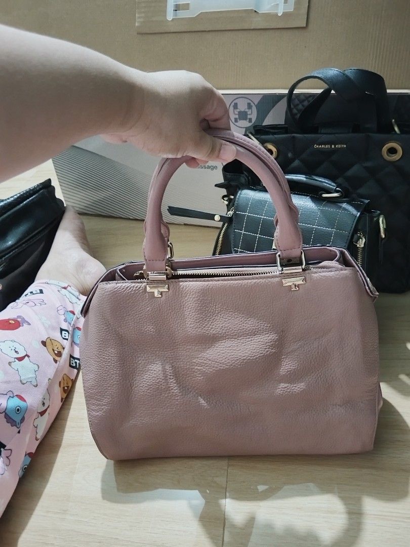 Pink Handbag with Top Handles (Category: Luxury Bags & Wallets) located in Binan City. Submitted by shopcarls (Listing ID 1413526413, Image 1). Description: - Top handles and zip closure - Features a charm - Multiple interior compartments - Textured material - Gold-colored hardware - Medium size - Ideal for everyday use Old rose in color.