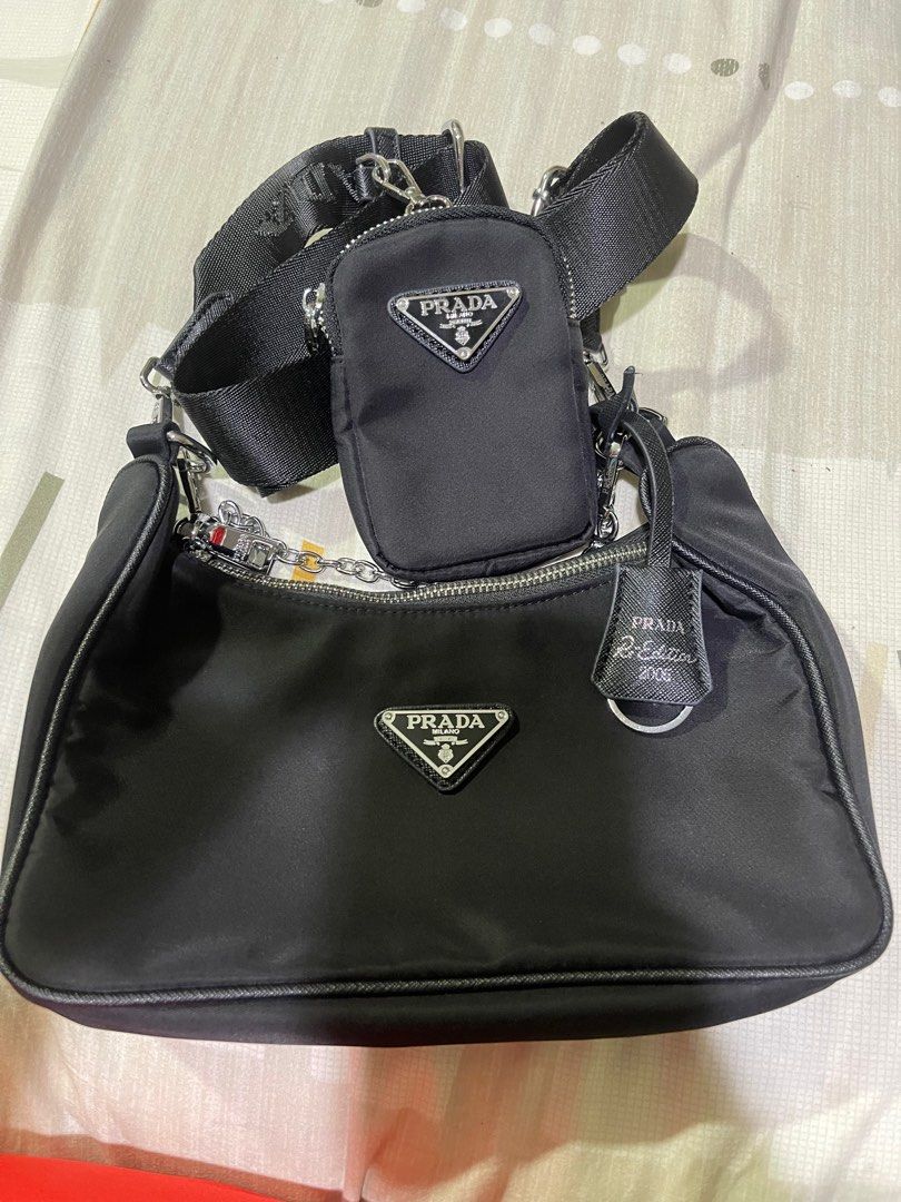 Prada Re-Edition 2005 Shoulder Bag (Category: Luxury Bags & Wallets) located in Rizal. Submitted by catchyfinds (Listing ID 1413613401, Image 2). Description: - Prada Re-Edition 2005 shoulder bag - Includes a detachable pouch - Silver-tone chain - Comes with box -Japan sourced .