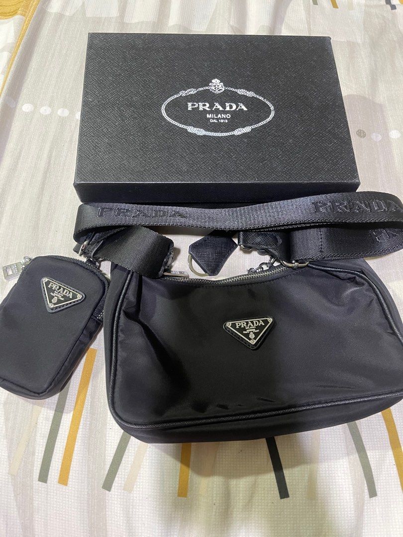 Prada Re-Edition 2005 Shoulder Bag (Category: Luxury Bags & Wallets) located in Rizal. Submitted by catchyfinds (Listing ID 1413613401, Image 1). Description: - Prada Re-Edition 2005 shoulder bag - Includes a detachable pouch - Silver-tone chain - Comes with box -Japan sourced .