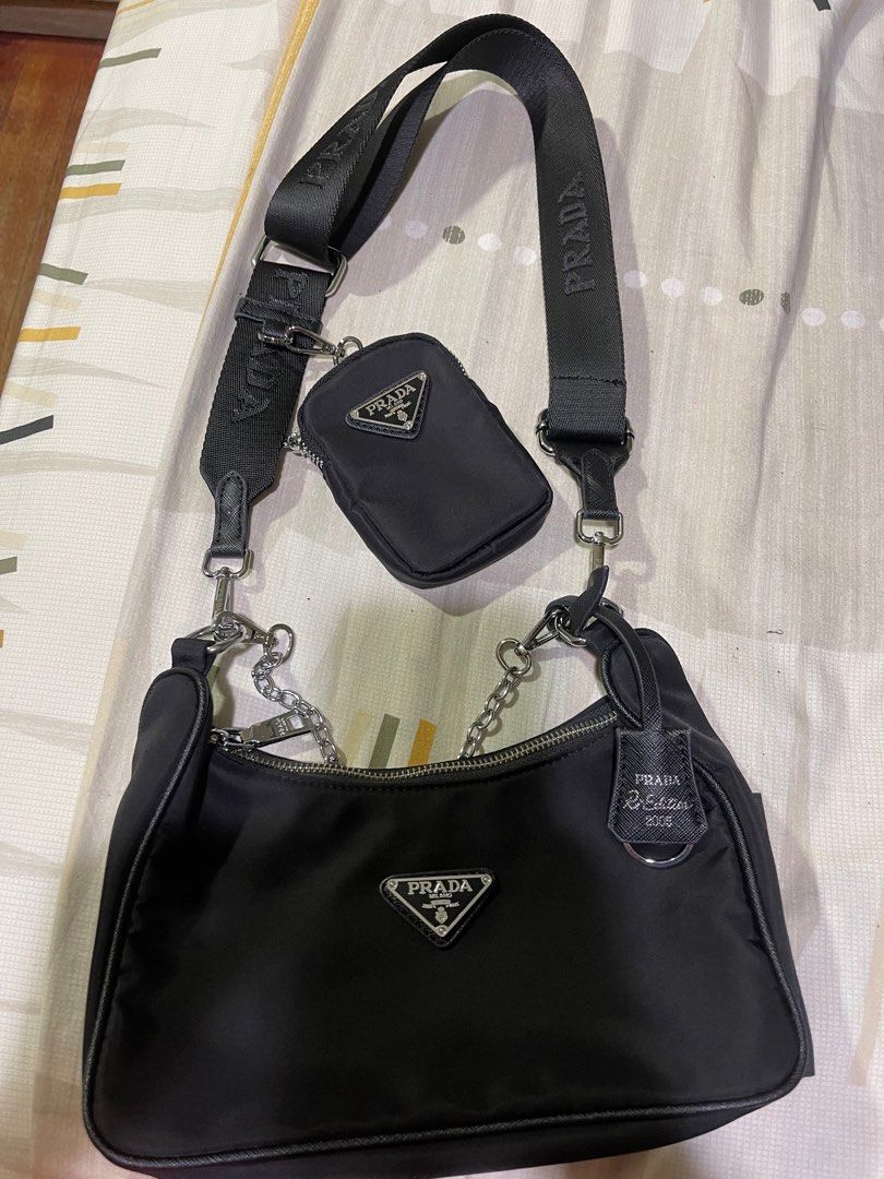 Prada Re-Edition 2005 Shoulder Bag (Category: Luxury Bags & Wallets) located in Rizal. Submitted by catchyfinds (Listing ID 1413613401, Image 3). Description: - Prada Re-Edition 2005 shoulder bag - Includes a detachable pouch - Silver-tone chain - Comes with box -Japan sourced .