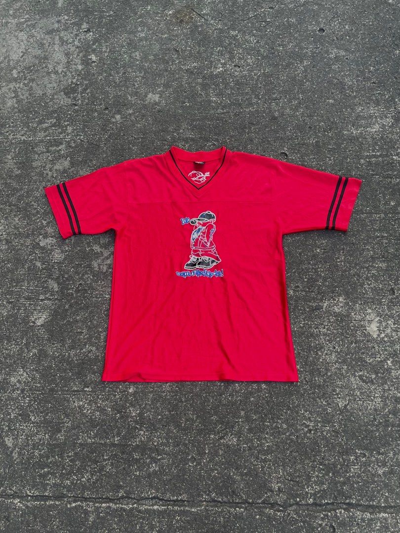 Ruff Ryders Bolo Graphic T-shirt (Category: Tshirts & Polo Shirts ) located in Manila. Submitted by alxanderctlan (Listing ID 1413508835, Image 1). Description: - Red Ruff Ryders T-shirt - Features a Bolo graphic on the front - V-neck design - Black stripes on sleeves and collar - Graphic of a person wearing a cap - Brand logo on collar - Back of shirt has cap graphic and "SOHK" logo.