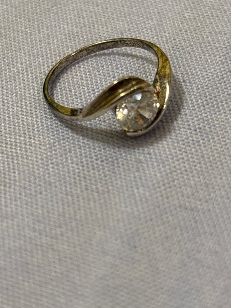 Silver Ring with Clear Stone (Category: Rings) located in Quezon City. Submitted by luxgoals (Listing ID 1413517830, Image 2). Description: - Silver ring with a clear, round-cut stone - Unique swirling band design - Comes with a clear, faceted box - Red velvet interior - Classic and elegant - Ideal gift or addition to a jewelry collection.