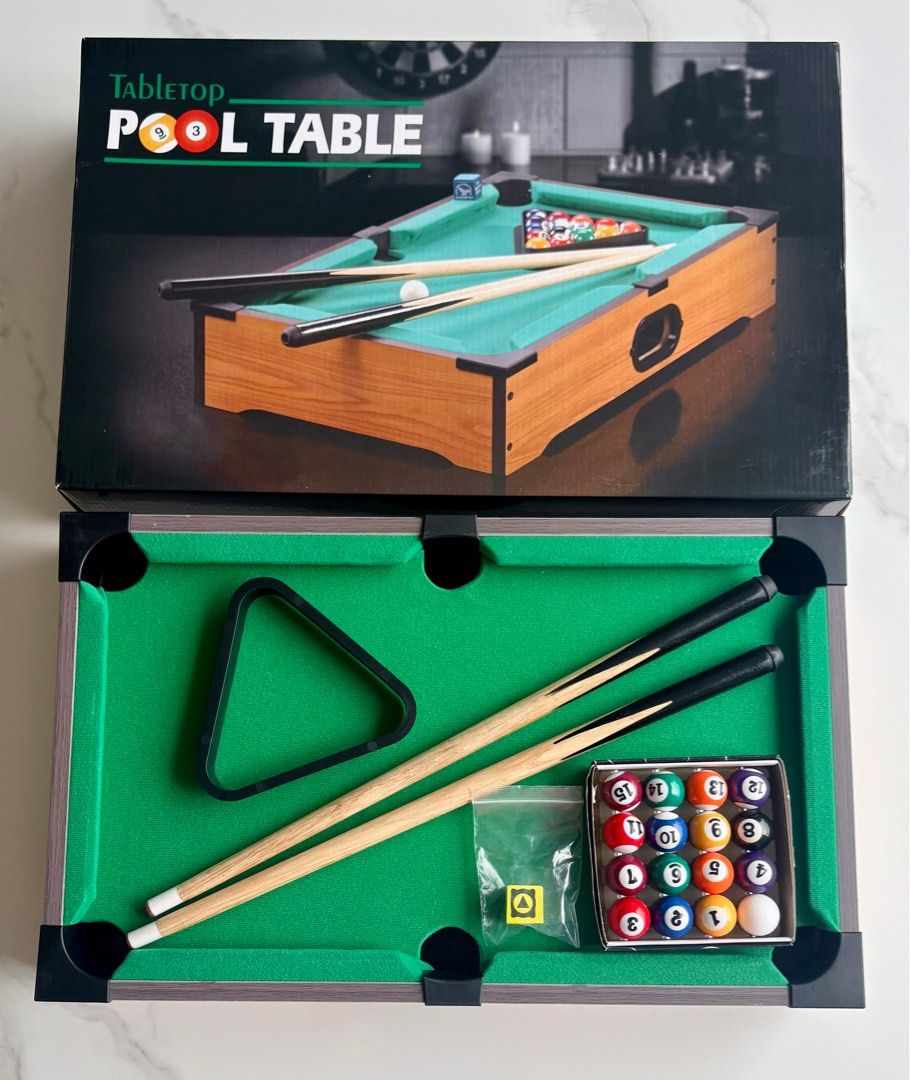 Tabletop Pool Table (Category: Board Games & Puzzles) located in Singapore. Submitted by sunflowerpeony14 (Listing ID 1413539484, Image 1). Description: - Tabletop pool table set. - Includes: - Pool table - Pool balls - Cues - Triangle - Perfect for home entertainment. - Ready to play! - Used once: As good as New.