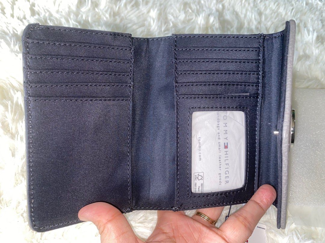TOMMY Hilfiger Nylon 2 fold nylon wallet (Category: Wallets & Card holders) located in Cabanatuan. Submitted by mixbrandeditems (Listing ID 1413518510, Image 3). Description: • 💯 Original Tommy Hilfiger wallet • Med gray wallet, inside is nylon. With 10 slots card holder, with zipper at the back for coins..