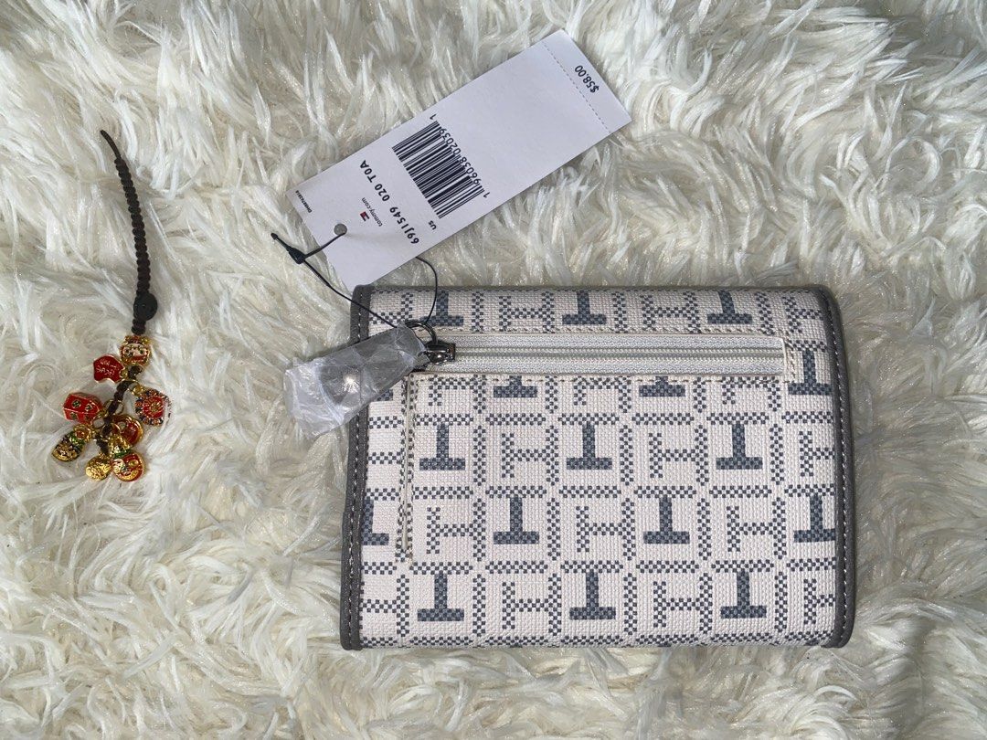 TOMMY Hilfiger Nylon 2 fold nylon wallet (Category: Wallets & Card holders) located in Cabanatuan. Submitted by mixbrandeditems (Listing ID 1413518510, Image 2). Description: • 💯 Original Tommy Hilfiger wallet • Med gray wallet, inside is nylon. With 10 slots card holder, with zipper at the back for coins..