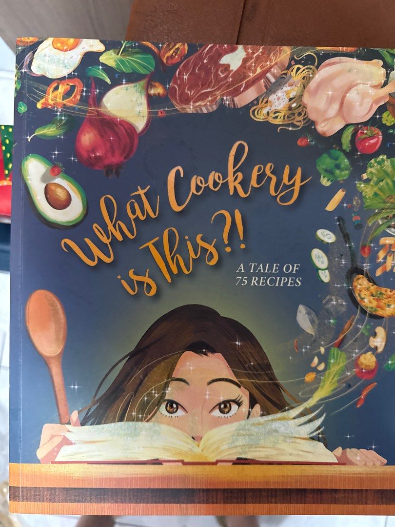 What Cookery is This?! Cookbook (Category: Storybooks) located in Quezon City. Submitted by timoshop (Listing ID 1413595735, Image 1). Description: Discover 75 delicious recipes in this cookbook! The cover features a vibrant illustration with various food items. It's perfect for anyone who loves to cook or wants to explore new culinary adventures. The book's title is "What Cookery is This?!" and it features a charming design..