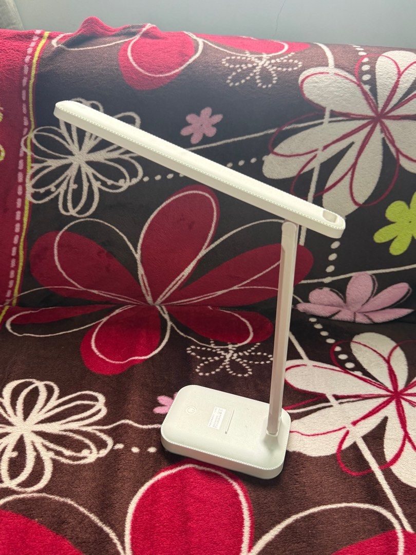White LED Desk Lamp (Category: Lighting) located in Manila. Submitted by dendennnnnnn_ (Listing ID 1413526803, Image 1). Description: - White LED desk lamp - Ideal for studying or working - Adjustable design for optimal lighting - Features a rectangular base - Long, slender light panel - In good working condition - With charging cord.