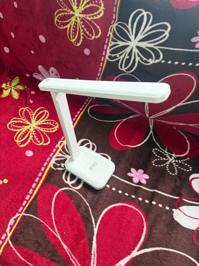 White LED Desk Lamp (Category: Lighting) located in Manila. Submitted by dendennnnnnn_ (Listing ID 1413526803, Image 2). Description: - White LED desk lamp - Ideal for studying or working - Adjustable design for optimal lighting - Features a rectangular base - Long, slender light panel - In good working condition - With charging cord.