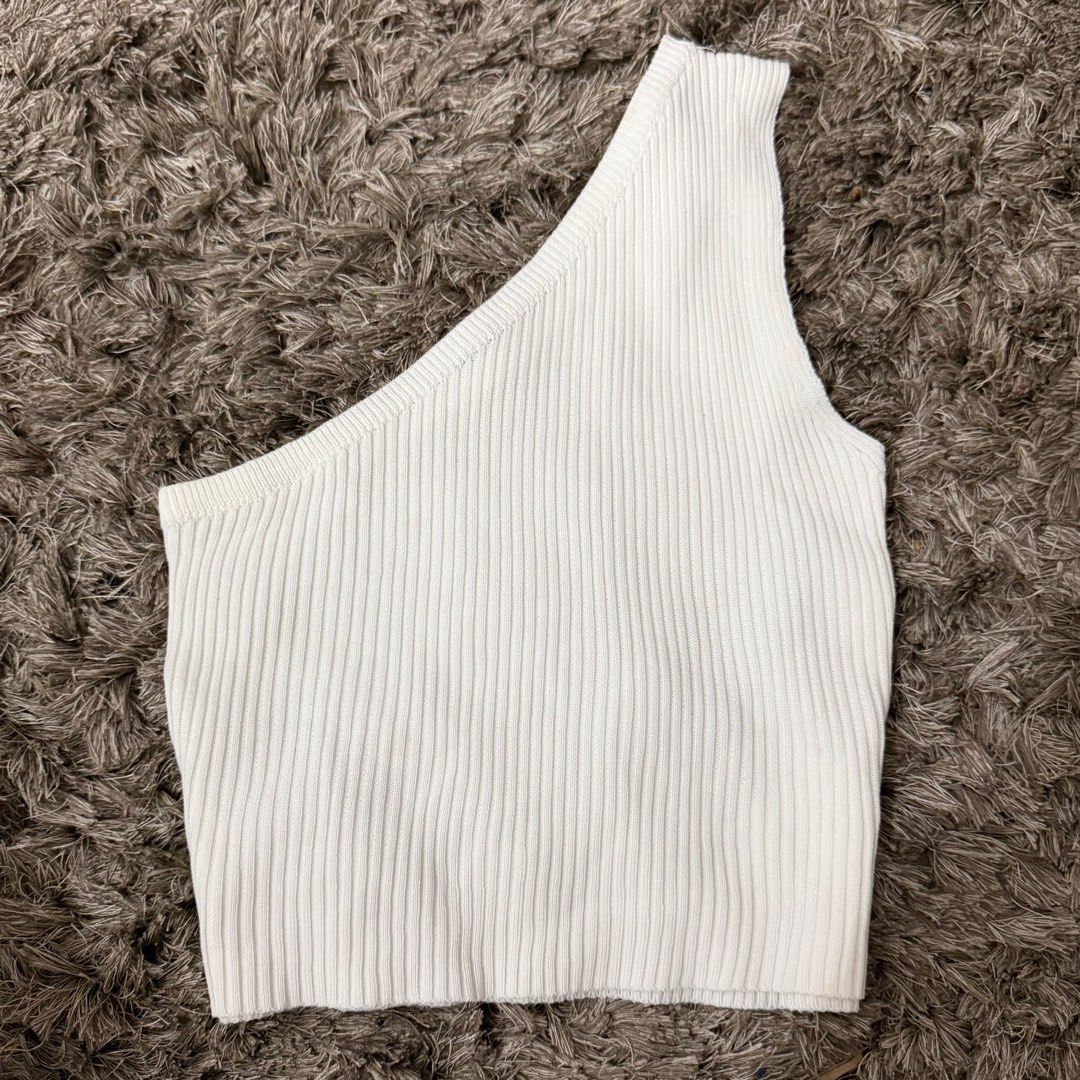 White One Shoulder Ribbed Top (Category: Sleeveless) located in Manila. Submitted by declutternclutter (Listing ID 1413459258, Image 1). Description: - Free Size - Ribbed - Stretchable - Good as New ✨ - No Stains, Pure White PS: Color may vary due to lighting and background - Too small for me .