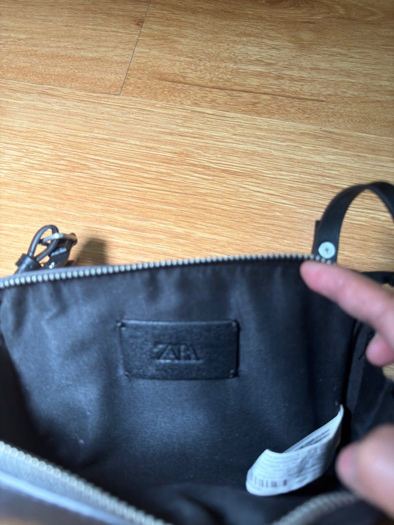 Zara Black Crossbody Bag unisex (Category: Cross-body Bags) located in Manila. Submitted by thegoodstuff.26 (Listing ID 1413521378, Image 3). Description: - Zara black crossbody bag - Rectangular shape - Zip closure - Adjustable long strap - Black interior -Brand new never used. Rfs: decluttering.