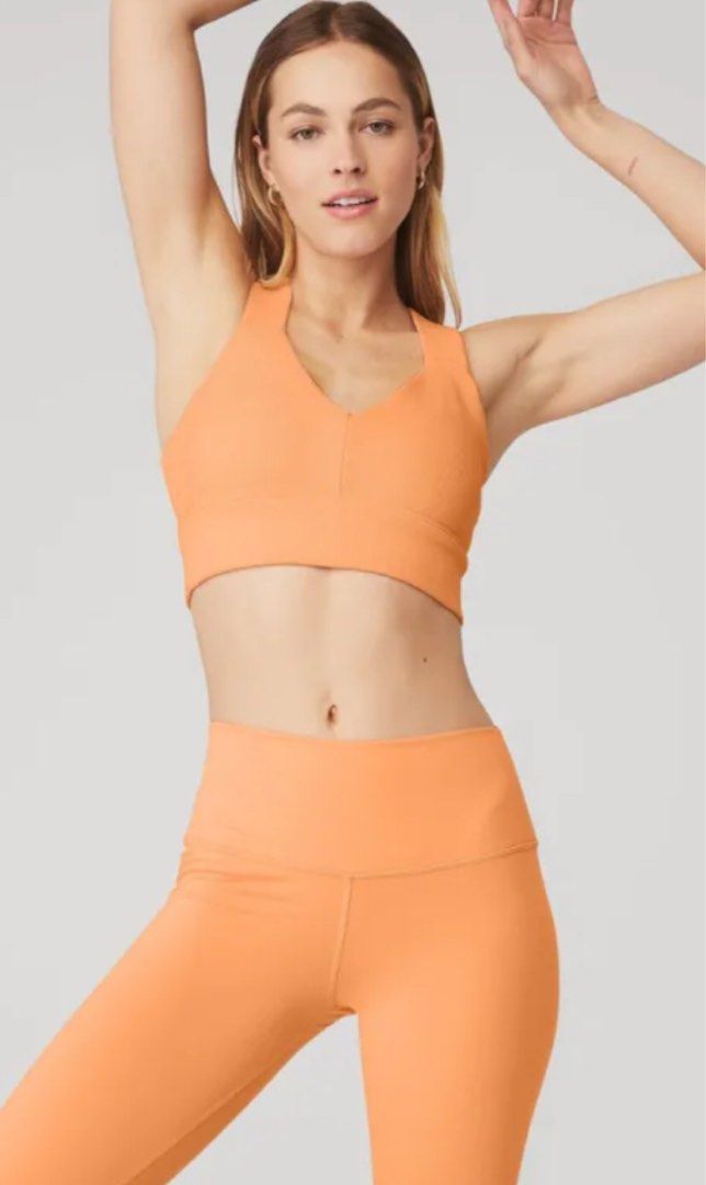 Alo Emulate Bra (Category: Activewear) located in Manila. Submitted by haveago0dthrift (Listing ID 1413793699, Image 1). Description: - Alo Yoga sports bra - Ribbed texture - Crossback design - V-neckline - Supportive band - Light orange color - Size: Large - Alo logo visible - Made in Vietnam -Width 28-34 -Length 14.