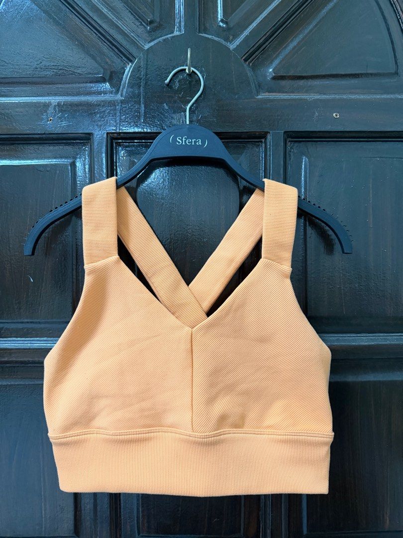 Alo Emulate Bra (Category: Activewear) located in Manila. Submitted by haveago0dthrift (Listing ID 1413793699, Image 2). Description: - Alo Yoga sports bra - Ribbed texture - Crossback design - V-neckline - Supportive band - Light orange color - Size: Large - Alo logo visible - Made in Vietnam -Width 28-34 -Length 14.
