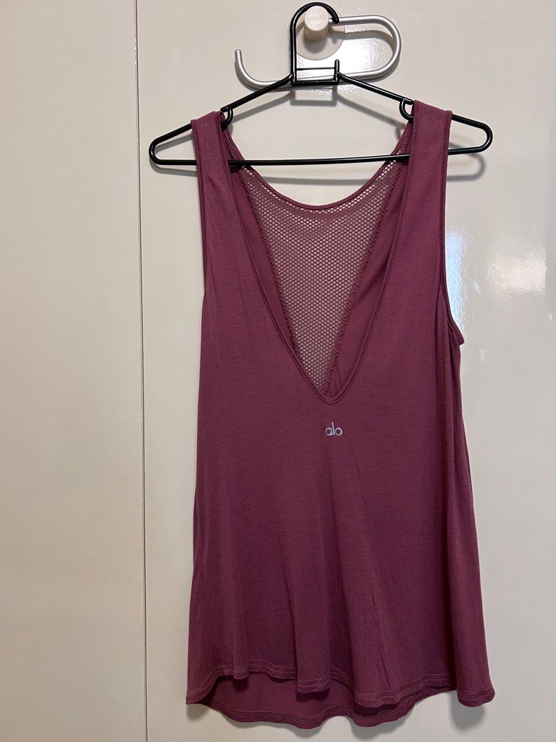 Alo Yoga Mesh Back Tank Top (Category: Activewear) located in Singapore. Submitted by magnolia1937 (Listing ID 1413752001, Image 2). Description: - Alo Yoga tank top - Stylish mesh front design, deep v bare back - Dusky purple color - Soft, buttery material - Minimal signs of wear - Perfect for yoga, workouts, and casual wear Hardly used. Letting go at a steep discount from purchase price.
