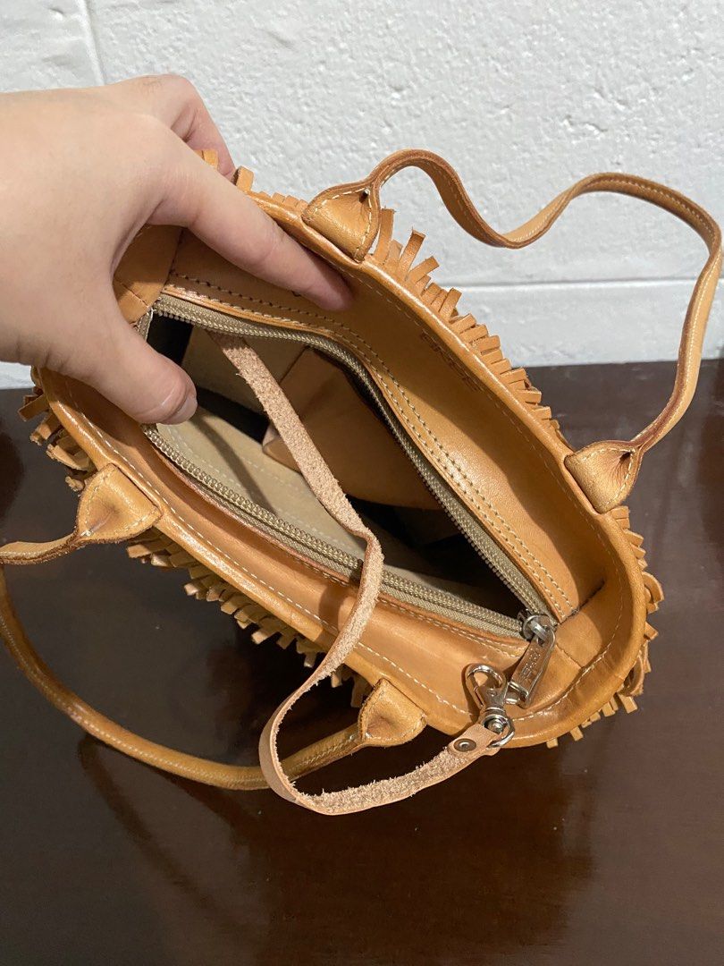Bree Fringe Handbag (Category: Luxury Bags & Wallets) located in Manila. Submitted by peachylola (Listing ID 1413750251, Image 3). Description: - Tan handbag with fringe detailing - Zipper closure - Interior pocket - Brand: "Bree" - Two handles - Price: PHP 500.