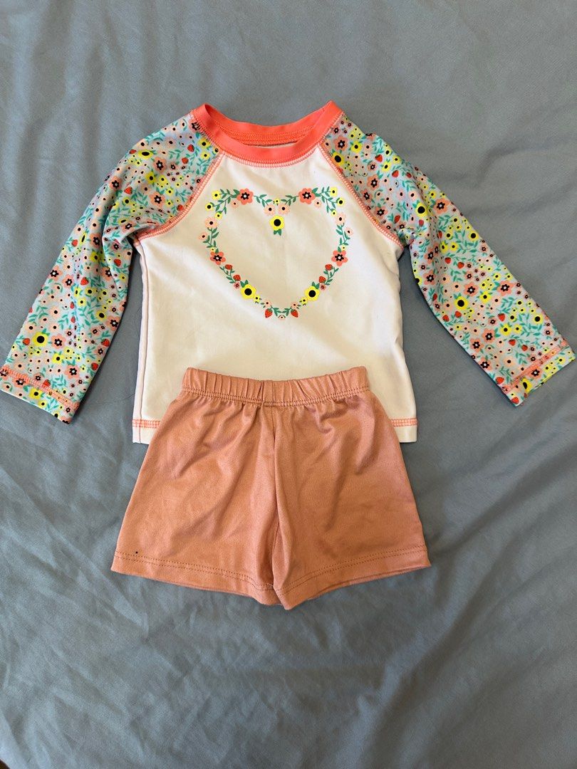 Cat & Jack Floral Swimsuit Set 12M (Category: Babies & Kids Fashion) located in Quezon City. Submitted by crslph (Listing ID 1413737344, Image 1). Description: - Cat & Jack baby swimsuit set - Size: 12 months - Features: - Long-sleeved top with floral heart design - Matching peach-colored shorts - Floral pattern on sleeves - Made in Vietnam.