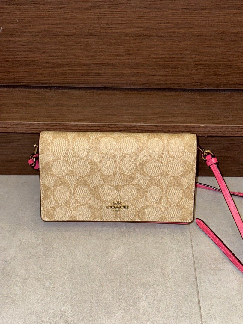 Coach Anna Crossbody Bag (Category: Luxury Bags & Wallets) located in San Fernando. Submitted by miso.ph (Listing ID 1413778918, Image 1). Description: - Coach crossbody bag - Signature Coach pattern on front - Pink back and strap - Interior with card slots and zippered compartment - Gold-tone Coach logo and hardware Issues: slight dents as seen on photo.