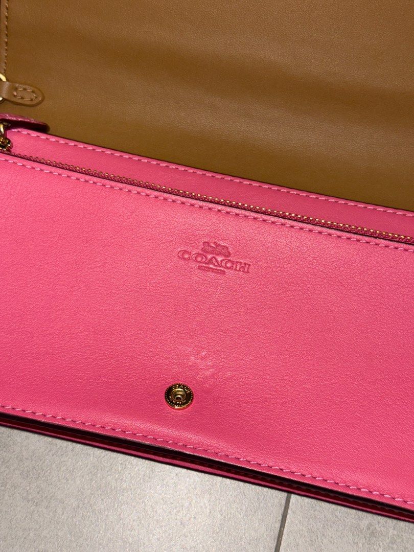 Coach Anna Crossbody Bag (Category: Luxury Bags & Wallets) located in San Fernando. Submitted by miso.ph (Listing ID 1413778918, Image 3). Description: - Coach crossbody bag - Signature Coach pattern on front - Pink back and strap - Interior with card slots and zippered compartment - Gold-tone Coach logo and hardware Issues: slight dents as seen on photo.