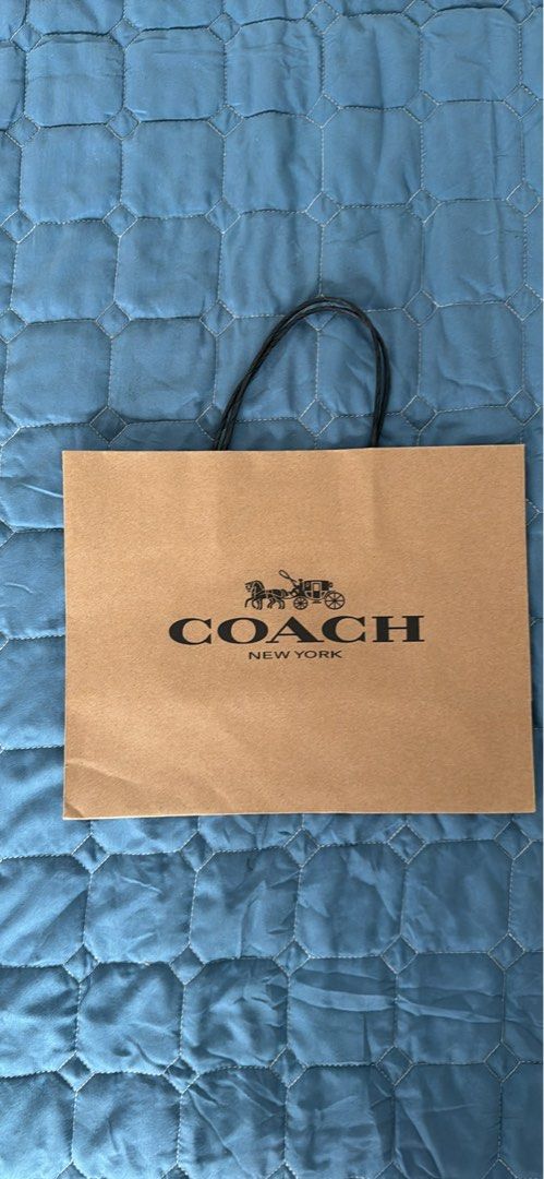 Coach Paper Bag (Category: Luxury Bags & Wallets) located in Manila. Submitted by kthlmllr (Listing ID 1413661922, Image 1). Description: - Authentic Coach paper bag - Features Coach logo and "New York" print - Brown color - Includes black handles - Ideal for gifting or storing Coach items.