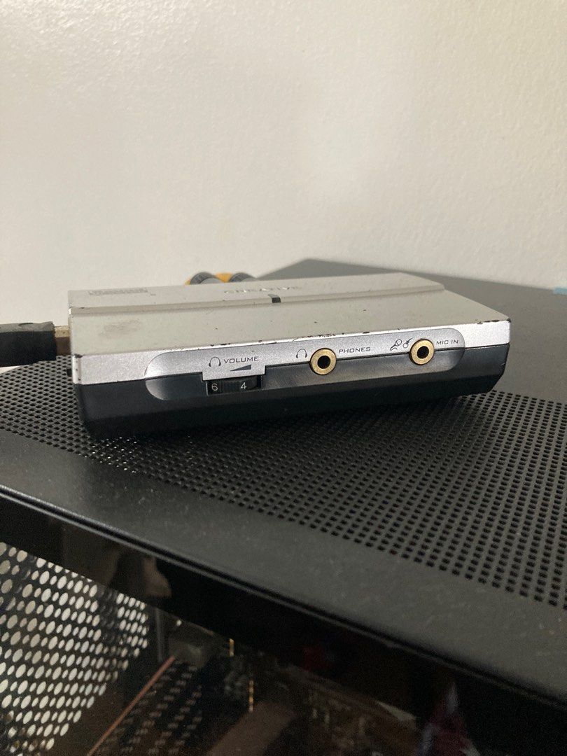 Creative Sound Blaster USB Sound Card (Category: Soundbars, Speakers & Amplifiers) located in Paniqui. Submitted by swiftdragon.c69cc8 (Listing ID 1413684536, Image 1). Description: - Creative Sound Blaster sound card - Volume control - Headphone jack - MIDI in/out ports - USB connection - Digital/analog output - Silver and black color scheme.