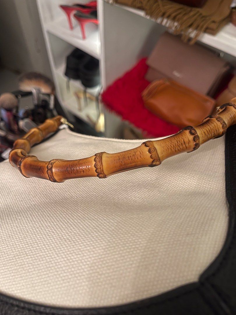 Guy Laroche Bamboo Handle Handbag (Category: Luxury Bags & Wallets) located in Marilao. Submitted by wardrovearchives (Listing ID 1413778036, Image 2). Description: - Guy Laroche handbag - Features a unique authentic bamboo handle - Stylish design - Black leather trim - Cream-colored canvas body - Gold lettering.