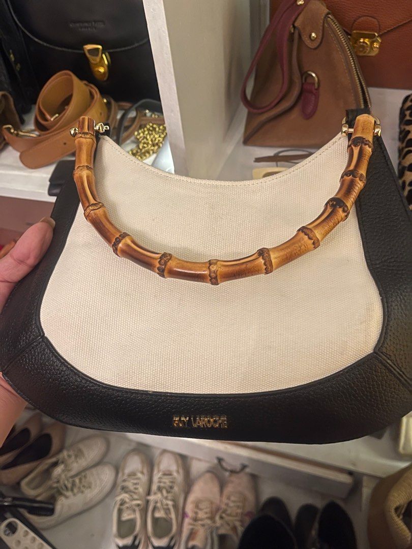Guy Laroche Bamboo Handle Handbag (Category: Luxury Bags & Wallets) located in Marilao. Submitted by wardrovearchives (Listing ID 1413778036, Image 1). Description: - Guy Laroche handbag - Features a unique authentic bamboo handle - Stylish design - Black leather trim - Cream-colored canvas body - Gold lettering.