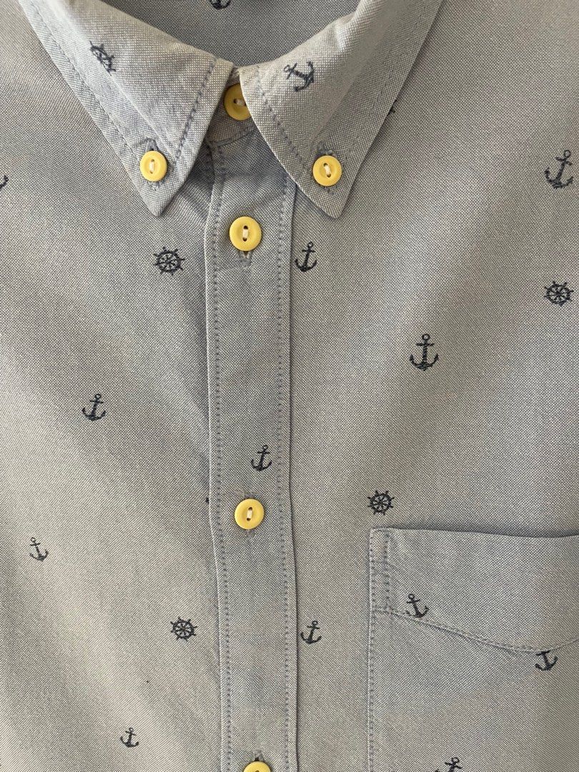 H&M Divided Anchor Print Shirt - Medium (Category: Shirts) located in Paranaque City. Submitted by melvinmarquez (Listing ID 1413676325, Image 3). Description: - H&M Divided shirt - Size: Medium - Design: Anchor and ship wheel print - Color: Light Blue - Features: - Button-down closure - Chest pocket - Buttoned cuffs - Fit: Regular 21 inch W x 30 inch L Issue: stain at the back as seen in photo.