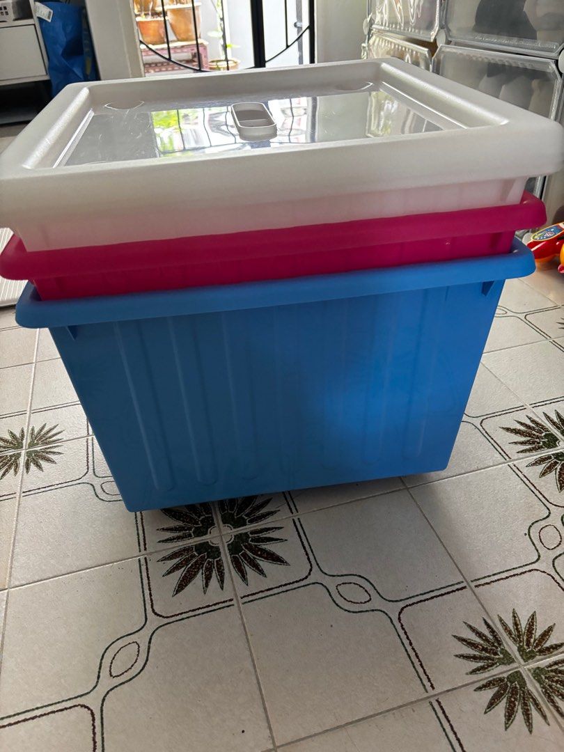 Plastic Storage Boxes with Lids stackable (Category: Storage Boxes & Baskets) located in Singapore. Submitted by qwenight (Listing ID 1413685404, Image 3). Description: Durable plastic storage boxes in blue, white, and pink. Includes lids for secure storage. Boxes are stackable Wheels below for easy movement 39 x 39 x 28 All in cm 1 for $7 3 for $20 Pick up - telok blangah Delivery - only if convenient and nearby .