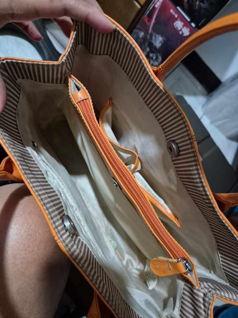 Light Orange Handbag (Category: Tote Bags) located in Quezon City. Submitted by jamcreates (Listing ID 1413799137, Image 3). Description: Light orange handbag, classic design Durable material with multiple compartments Super Good condition (pls check photos), super minimal flaws Loc: Proj 7, QC.