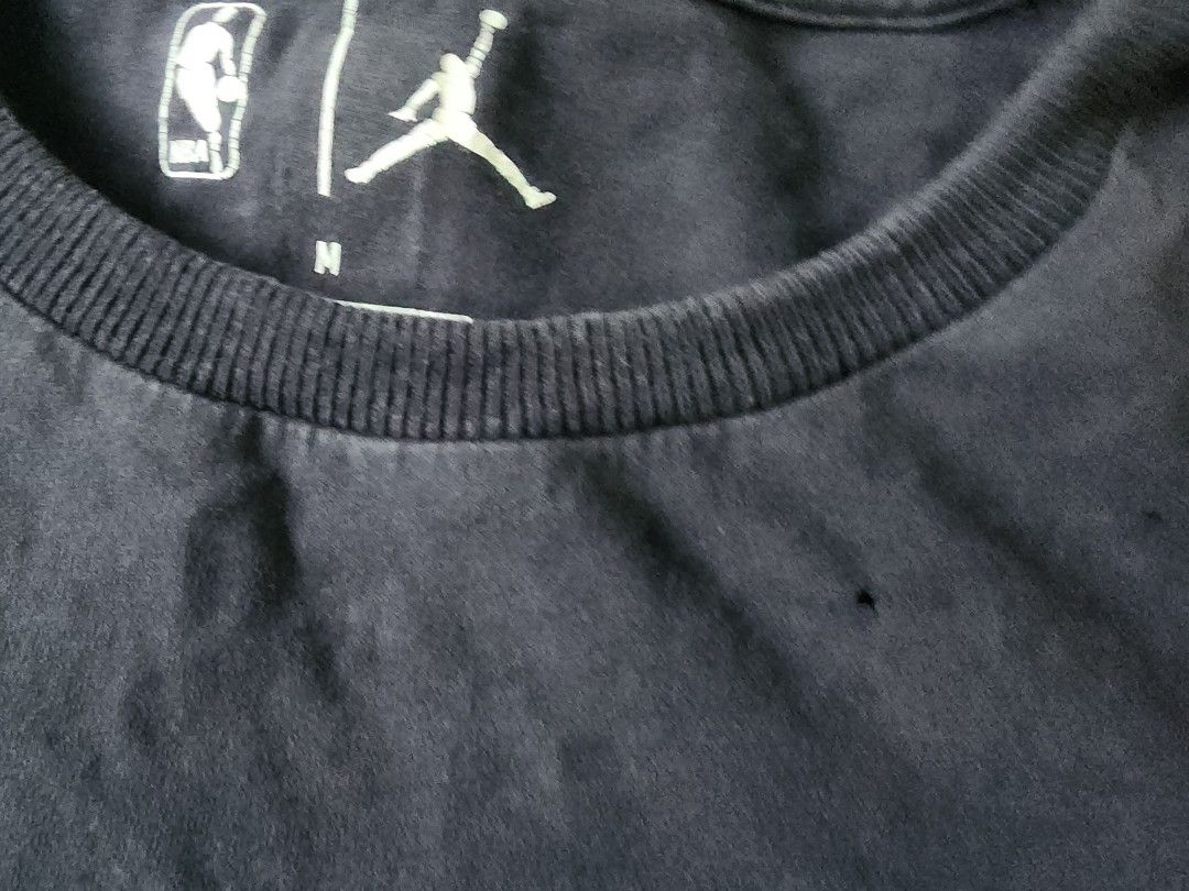 Mavericks luca Doncic 77 T-shirt (Category: Tshirts & Polo Shirts ) located in Manila. Submitted by cardano (Listing ID 1413843103, Image 3). Description: Black Jordan T-shirt featuring the Mavericks logo and Doncic's number 77. The shirt has a crew neck and the NBA logo is visible. The size is M. The shirt has some minor imperfections, including a small hole near the collar. The back of the shirt displays Doncic's name and number..