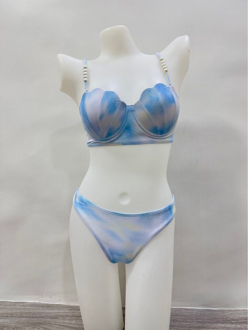 Mermaid Shell Two-Piece Swimsuit with Sarong (Category: Bikinis & Swimsuits) located in Taguig. Submitted by gelpingol (Listing ID 1413821957, Image 3). Description: - Mermaid shell bikini set - Can fit to S-M - Features pearl-detailed straps - Includes bikini top, bottom, and matching sarong - Blue and white tie-dye fabric - Scalloped edge on top - Adjustable straps - Sarong can be styled in multiple ways.