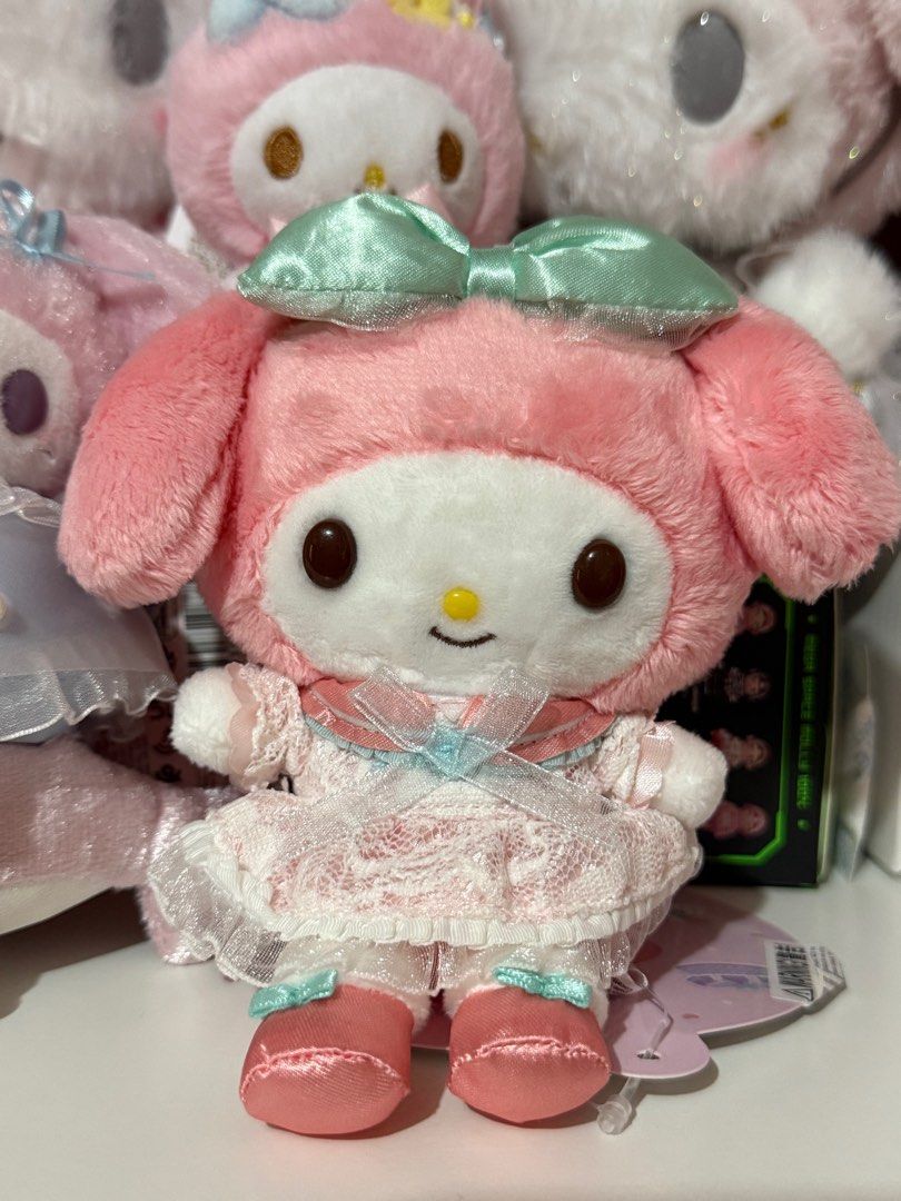 My Melody 50th Anniversary Charm (Category: Character Goods) located in Bocaue. Submitted by yncheoli (Listing ID 1413669391, Image 1). Description: - My Melody 50th Anniversary Plush - Features a cute pink plush design - Includes matching dress and bow - Comes with a convenient keychain - Collectible item for My Melody fans - Tag showcases different outfits.
