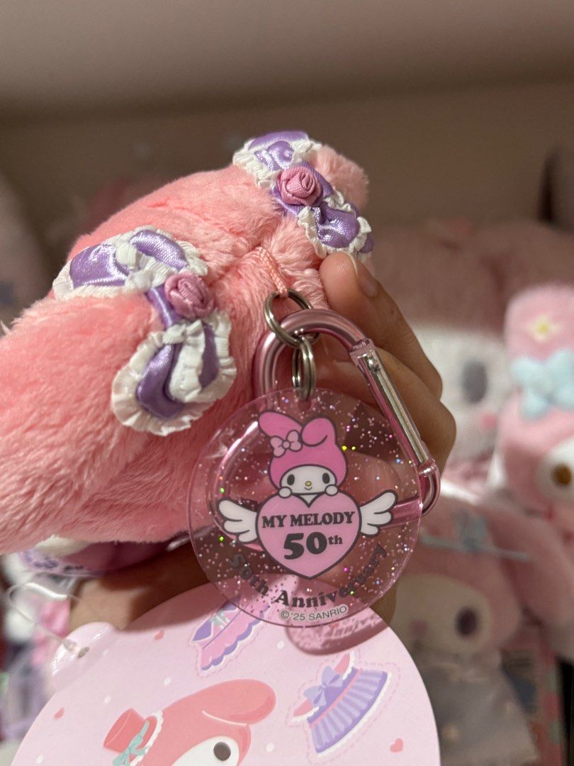 My Melody 50th Anniversary Plush Charm (Category: Character Goods) located in Bocaue. Submitted by yncheoli (Listing ID 1413668866, Image 3). Description: - My Melody 50th Anniversary Plush Keychain - Features My Melody in a pink and purple dress. - Includes keychain attachment. - Clear tag with anniversary logo. - Original tag still attached. - Cute and collectible!.