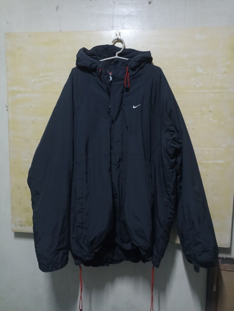 Nike puffer jacket (winter clothes) (Category: Coats, Jackets and Outerwear) located in Manila. Submitted by freespace01 (Listing ID 1413709285, Image 2). Description: - Dark navy Nike puffer hooded jacket - Size: XXL on tag (shoulder 18-19 inch length 30 inch) - Features a small white Nike logo - Hood with red drawstrings rfs decluttering.