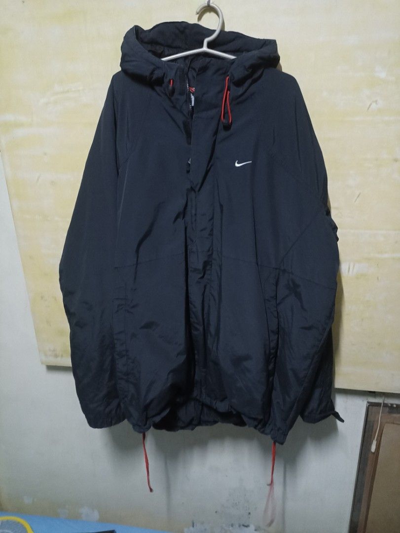 Nike puffer jacket (winter clothes) (Category: Coats, Jackets and Outerwear) located in Manila. Submitted by freespace01 (Listing ID 1413709285, Image 3). Description: - Dark navy Nike puffer hooded jacket - Size: XXL on tag (shoulder 18-19 inch length 30 inch) - Features a small white Nike logo - Hood with red drawstrings rfs decluttering.