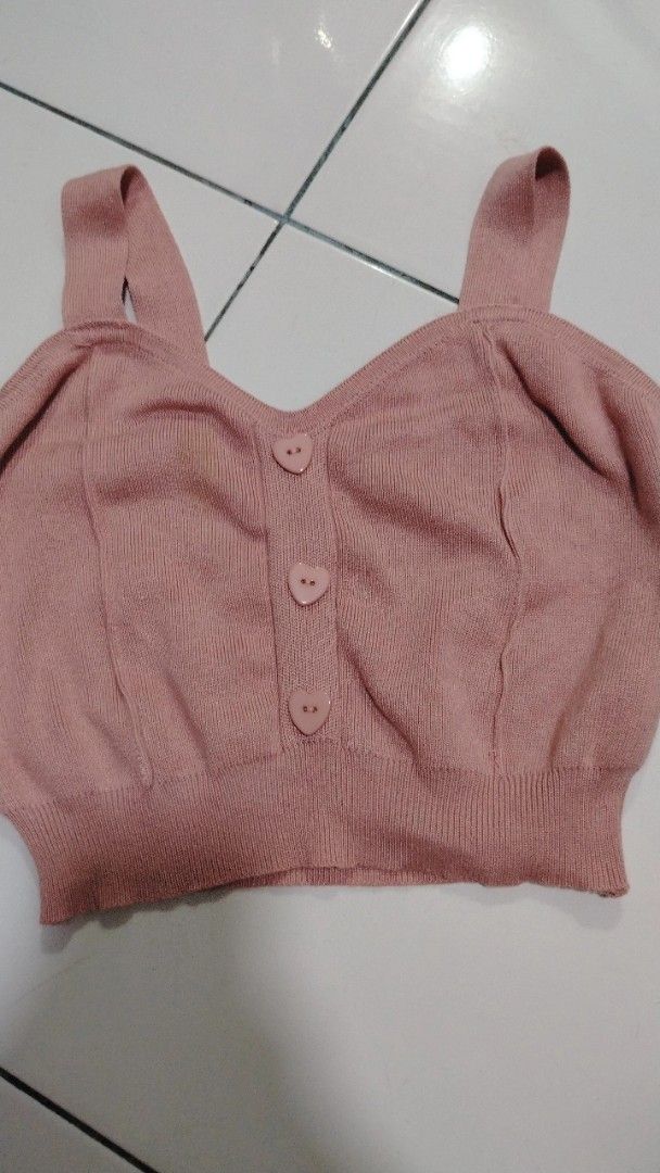 Pink Knitted Top with Heart Buttons (Category: Sleeveless) located in Manila. Submitted by loveeroded (Listing ID 1413764061, Image 1). Description: Can fit S to M. Pink knitted top features a V-neckline and heart-shaped buttons down the front. It has thick straps and a ribbed hem. With light stain (seen on pic). The top is a solid pink color. A cute and stylish addition to any wardrobe..