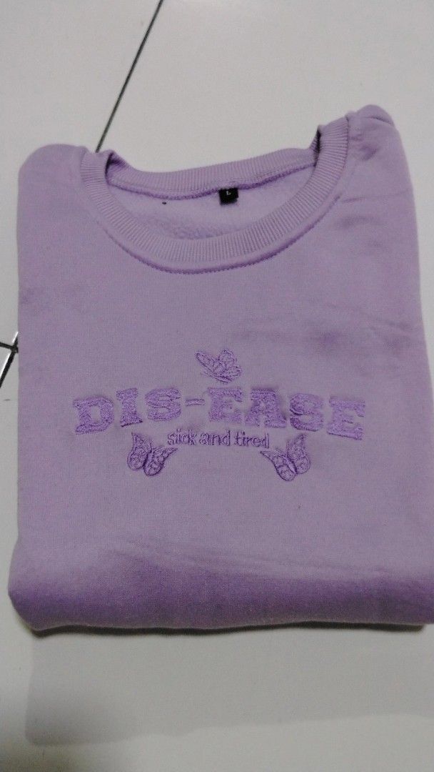 Purple Embroidered Sweatshirt (Category: Coats, Jackets and Outerwear) located in Manila. Submitted by loveeroded (Listing ID 1413765534, Image 3). Description: Purple sweatshirt features an embroidered design with the words "DIS-EASE" and "sick and tired", along with butterfly motifs. It has a crew neck and long sleeves..