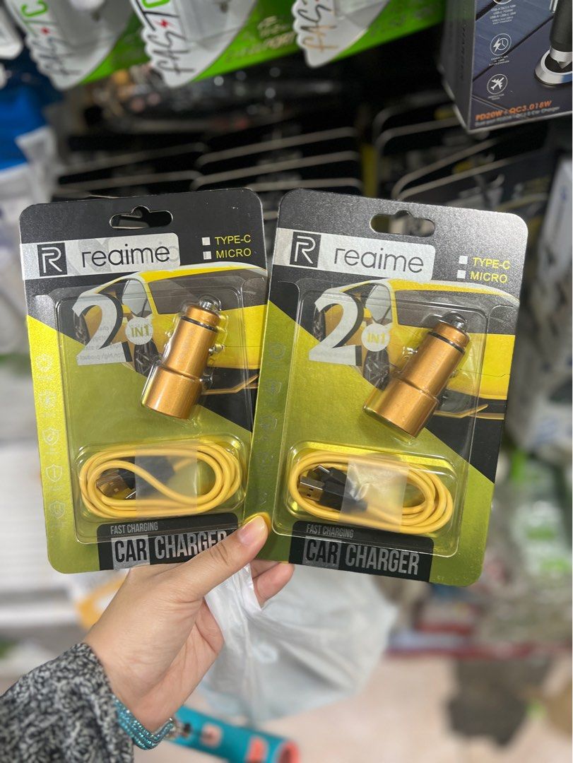 Realme 2-in-1 Fast Charging Car Charger Type-c | micro (Category: Chargers & Cables) located in Manila. Submitted by as_onlineshop11 (Listing ID 1413698193, Image 1). Description: - Realme car charger - Fast charging - 2-in-1 design: Type-C and Micro USB compatible - Gold color - Includes yellow cable - Perfect for car charging.