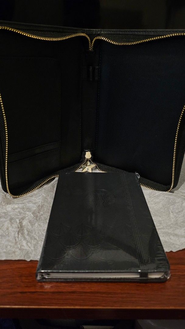 Starbucks 2022 Classic Black Organizer with Planner (Category: Stationery & School Supplies) located in Quezon City. Submitted by johnsandhens (Listing ID 1413699906, Image 3). Description: The organizer included built-in pockets designed to hold a pen, Starbucks cards, and other essentials. Interior Pages: Inside, the planner contained: Weekly and monthly calendar pages. 35 dotted blank pages for notes and journaling. 12 exclusive monthly artwor
