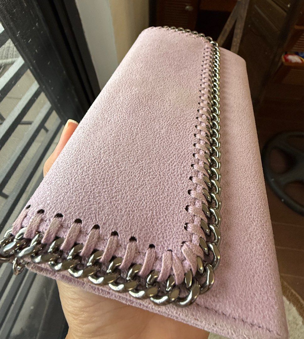 Authentic Stella McCartney Chain Wallet (Category: Luxury Bags & Wallets) located in Binangonan. Submitted by pinkesceeluxe (Listing ID 1413815082, Image 3). Description: - 100% Authentic or Money Back (provided you have a documentation from a Third-Party Authenticator) - Light pink / Light lilac wallet (color varies depending on lighting) - Chain detail - Suede fabric - Snap closure - Multiple card slots - Zippered compartment - Stella McCartney