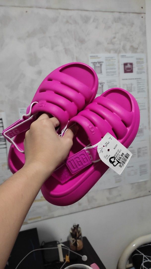 UGG Women's Pink Sandals (Category: Flats & Sandals) located in Las Pinas. Submitted by ceejayeusebio (Listing ID 1413819507, Image 1). Description: - Authentic UGG sandals - Vibrant pink color - Padded design for comfort - Includes original tags - Features UGG logo strap - Pink soles ‼️RFS: Bigay lang sakin. The color doesn't suit me. Never been worn. 🚚 Delivery - Shouldered by buyer 📍Location - Las Piñas 💵 Mode of Payment; -Bank Transfer -Gc