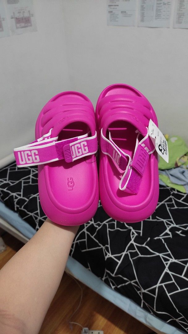 UGG Women's Pink Sandals (Category: Flats & Sandals) located in Las Pinas. Submitted by ceejayeusebio (Listing ID 1413819507, Image 3). Description: - Authentic UGG sandals - Vibrant pink color - Padded design for comfort - Includes original tags - Features UGG logo strap - Pink soles ‼️RFS: Bigay lang sakin. The color doesn't suit me. Never been worn. 🚚 Delivery - Shouldered by buyer 📍Location - Las Piñas 💵 Mode of Payment; -Bank Transfer -Gc