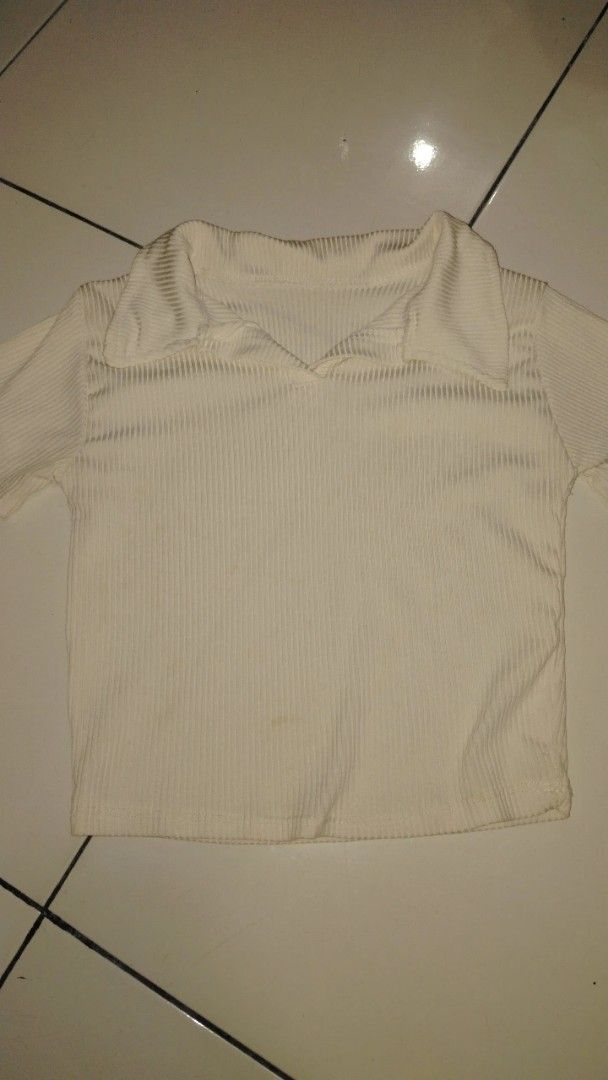 White Ribbed Polo Top (Category: Blouses) located in Manila. Submitted by loveeroded (Listing ID 1413764062, Image 2). Description: - Cream-colored ribbed polo top - Collared neckline - Short sleeves - Cropped style - Vertical ribbing - Minor stains on front.