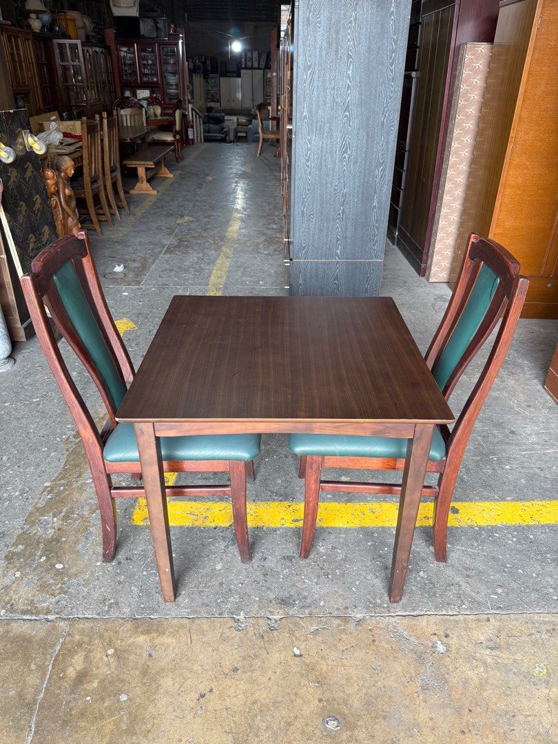 Wooden Dining Table with 2 Chairs (Category: Tables & Sets) located in Angeles City. Submitted by maryannmar33098 (Listing ID 1413850751, Image 2). Description: - Compact dining set ideal for small spaces. - Includes a wooden table and two chairs. - Chairs feature green cushioned seats and dark wood frames. - Table has a matching dark wood finish. - Sturdy and well-maintained. - Ready for immediate use..