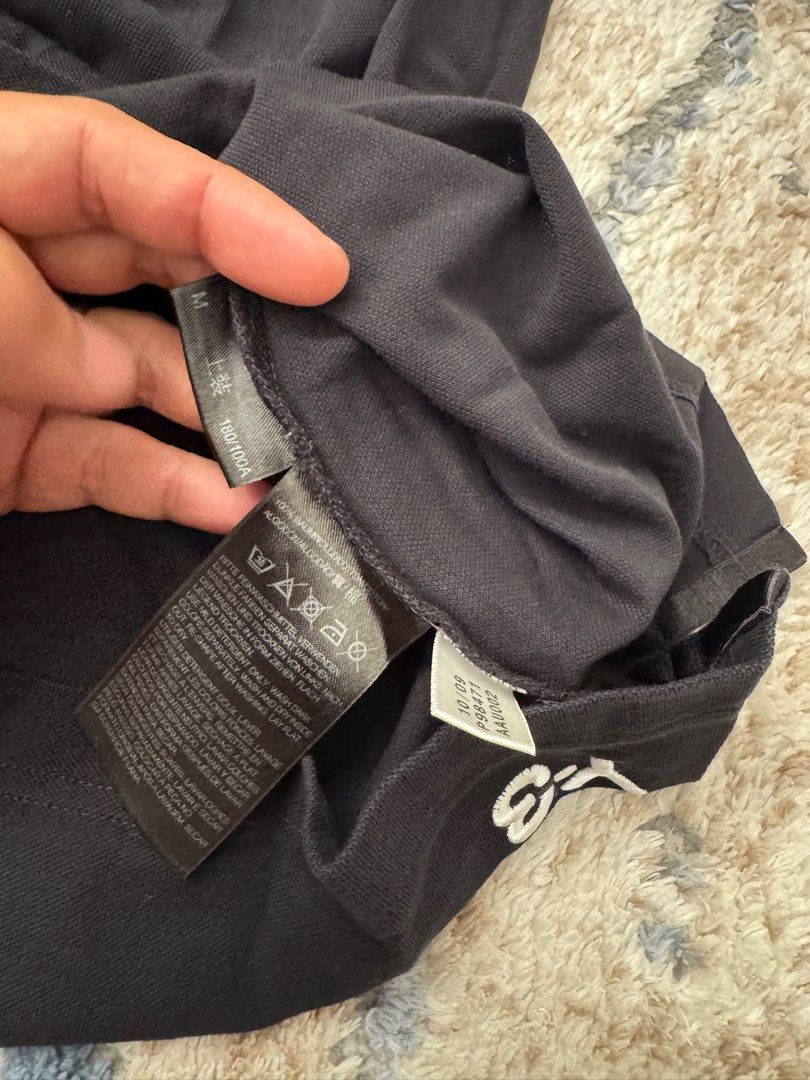Y-3 Yohji Yamamoto Adidas Polo Shirt - Black - M (Category: Tshirts & Polo Shirts) located in Singapore. Submitted by mzbar (Listing ID 1413676562, Image 3). Description: - Authentic Y-3 polo shirt - Color: Black - Size: M - Condition: Good (minimal wear) - Features: Unique button design, Y-3 logo on back - Made in Thailand - Stylish addition to your wardrobe.