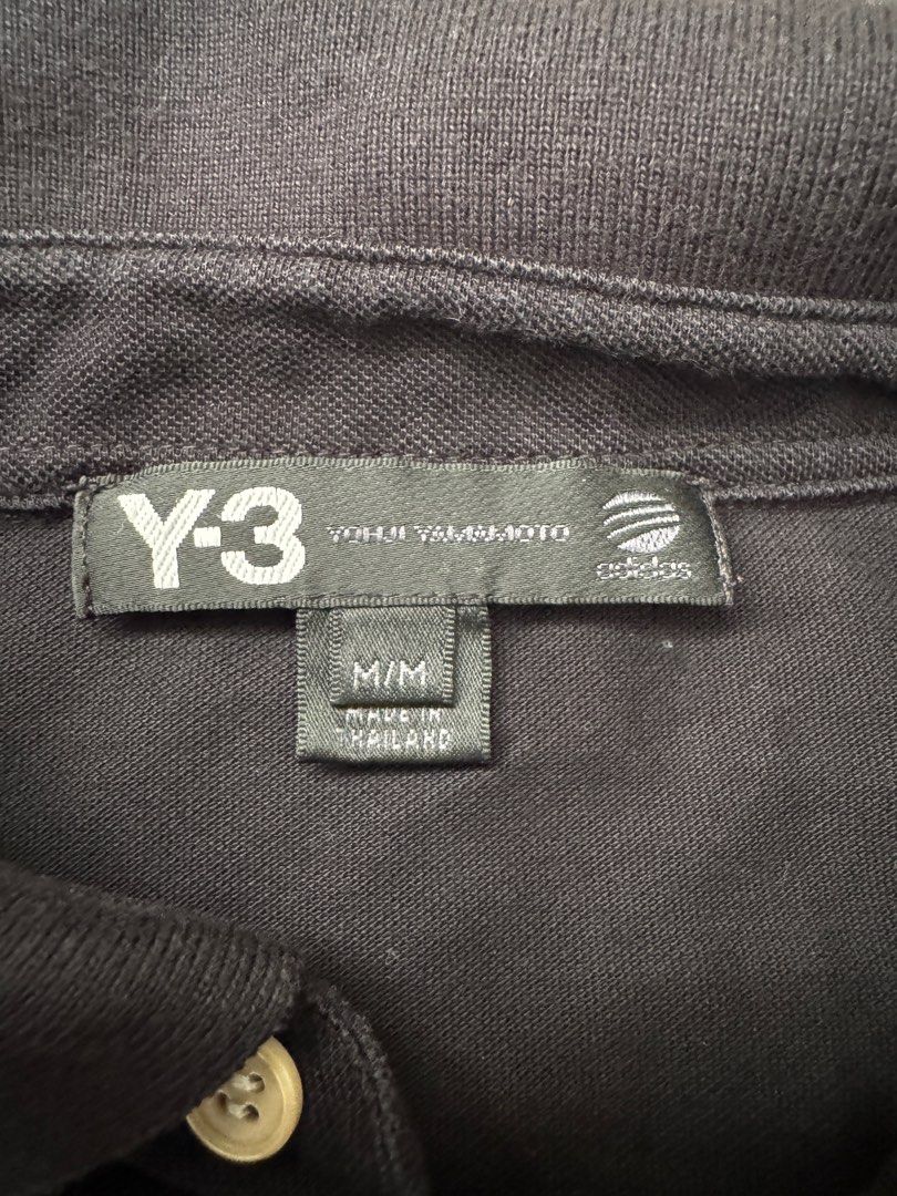 Y-3 Yohji Yamamoto Adidas Polo Shirt - Black - M (Category: Tshirts & Polo Shirts) located in Singapore. Submitted by mzbar (Listing ID 1413676562, Image 2). Description: - Authentic Y-3 polo shirt - Color: Black - Size: M - Condition: Good (minimal wear) - Features: Unique button design, Y-3 logo on back - Made in Thailand - Stylish addition to your wardrobe.